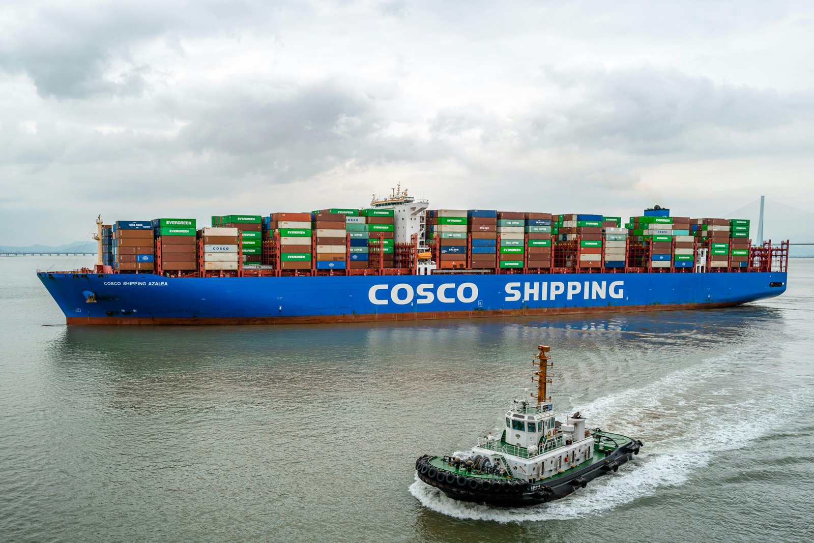 A large COSCO container ship navigates the waters of Ningbo Harbor, China.